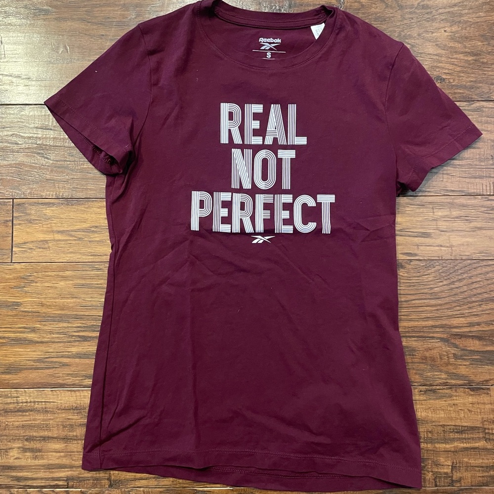 Reebok “Real Not Perfect” Women’s T-Shirt.